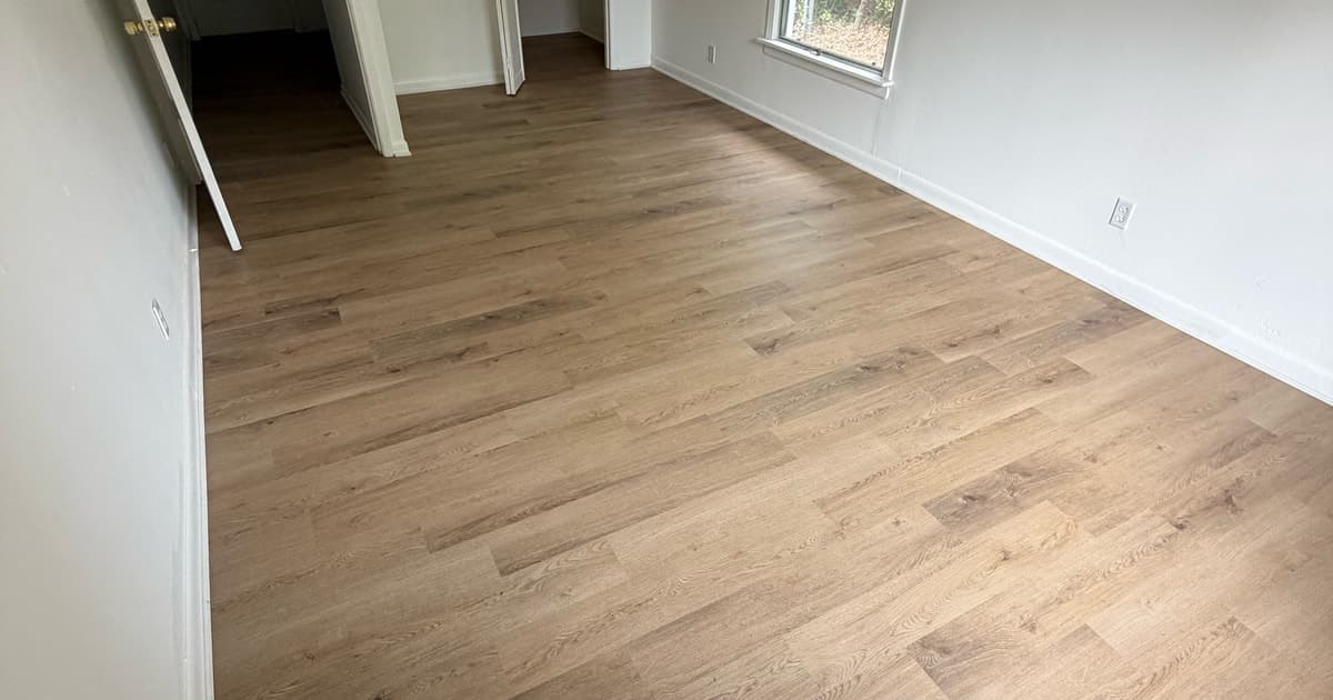 Completed wood-look plank flooring across a room in a Longview Texas home