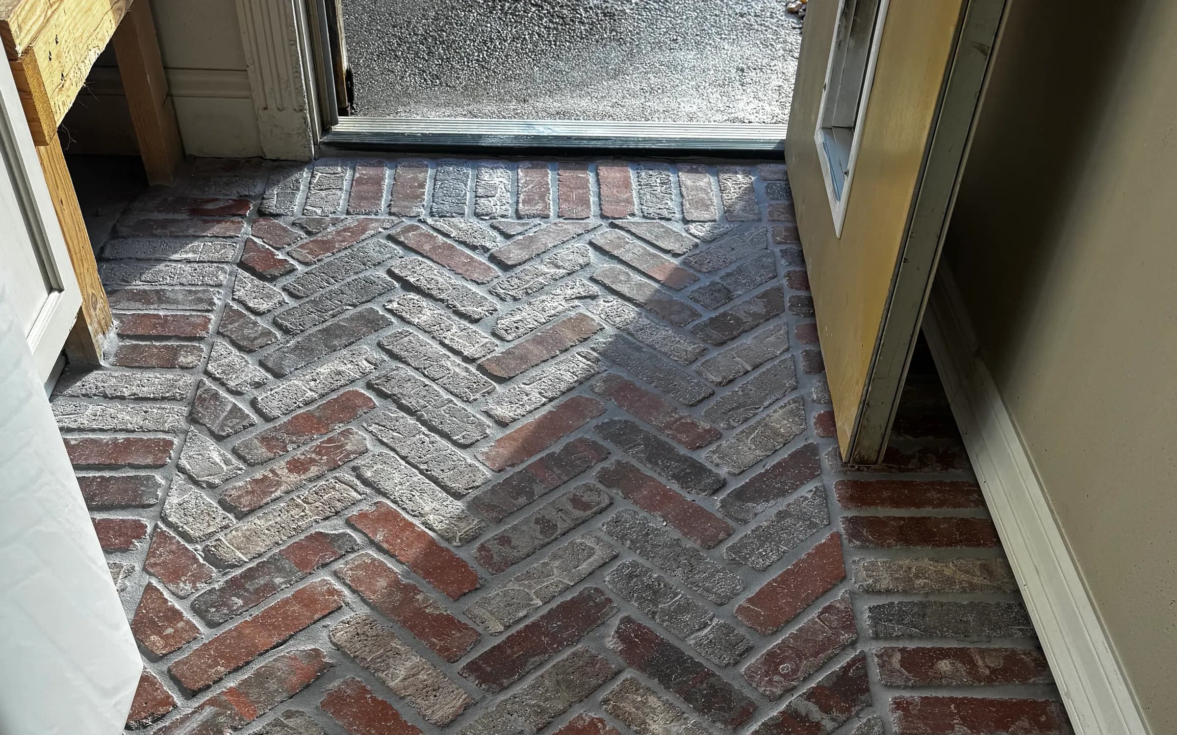 Multi-tone herringbone brick paver laundry room floor with a straight border in White Oak TX