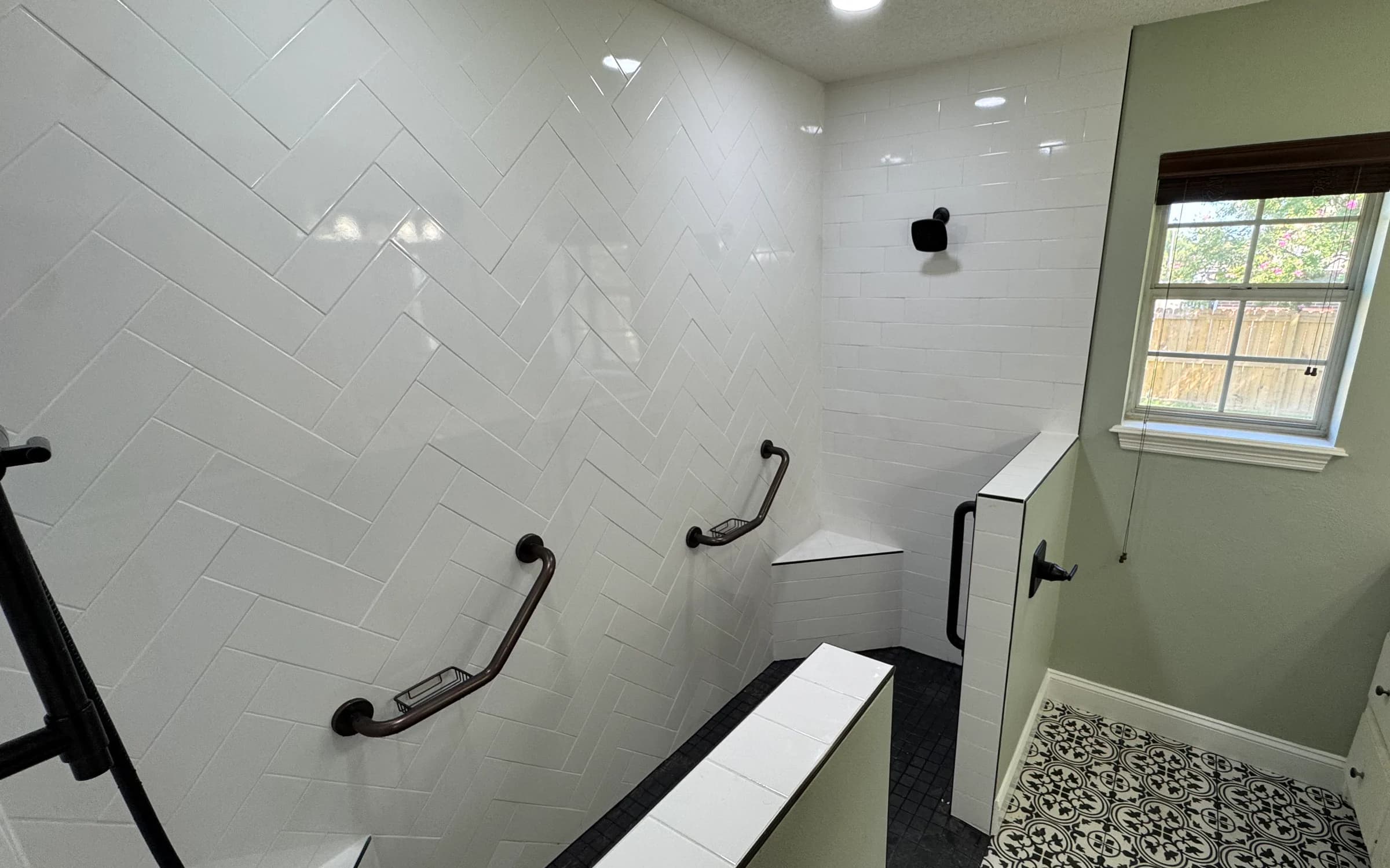 Custom tiled shower and black-and-white patterned bathroom flooring in Whitehouse TX