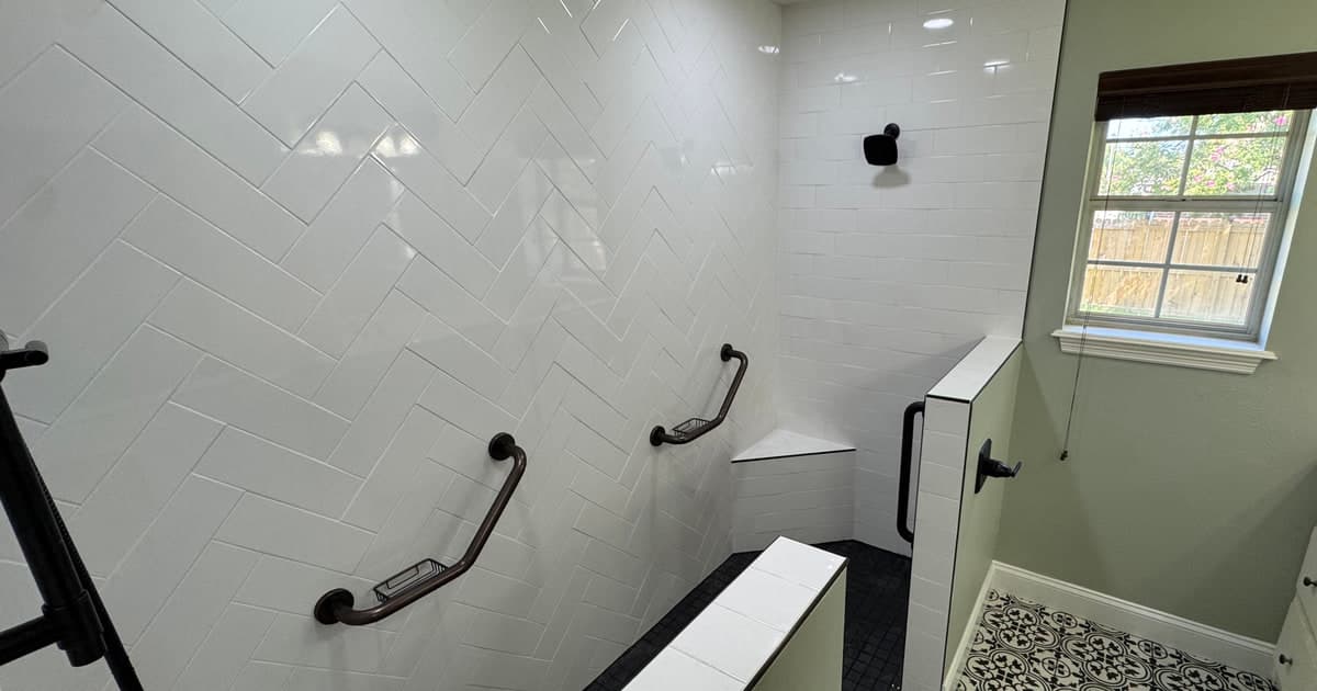 Custom tiled shower and black-and-white patterned bathroom flooring in Whitehouse TX