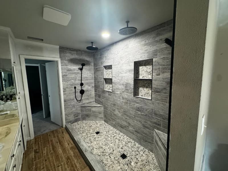Walk-in custom shower with stone tile and glass