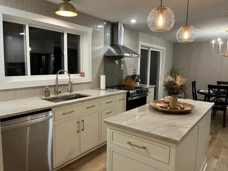 Modern white kitchen remodel with updated cabinetry and lighting